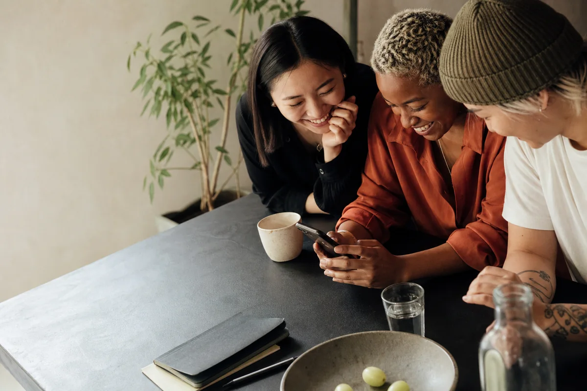 Friends sharing a warm moment together around a phone